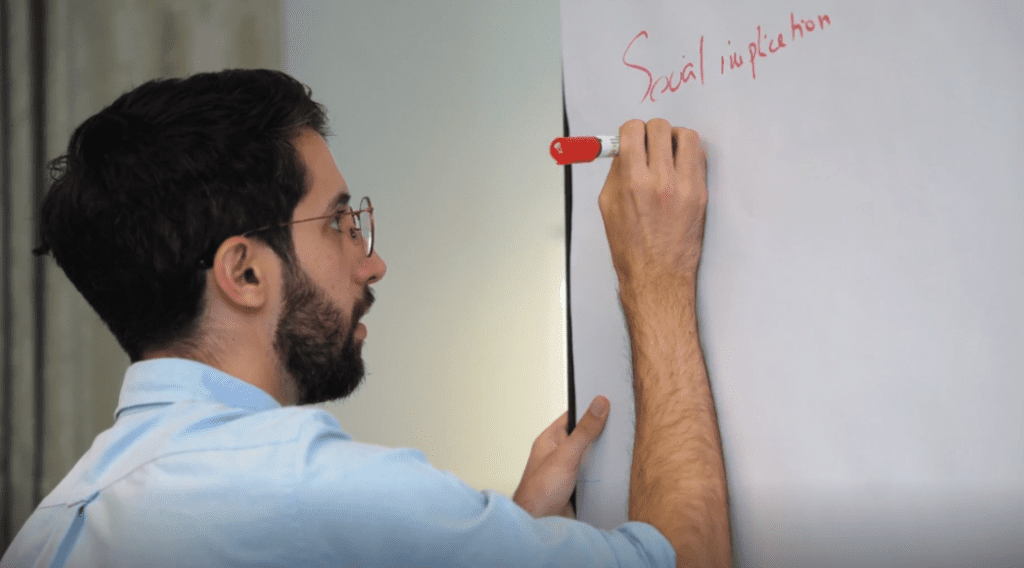 A person writes on a whiteboard at the blockchain training programme.