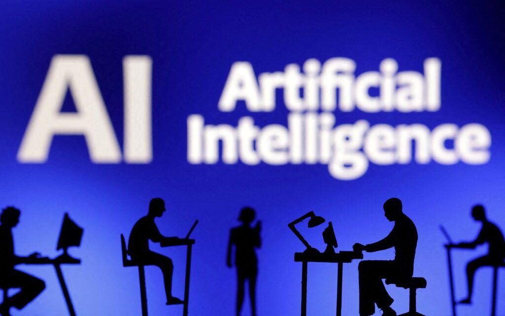 Figurines with computers and smartphones are seen in front of the words "Artificial Intelligence AI" in this illustration taken, February 19, 2024.. REUTERS/Dado Ruvic/Illustration