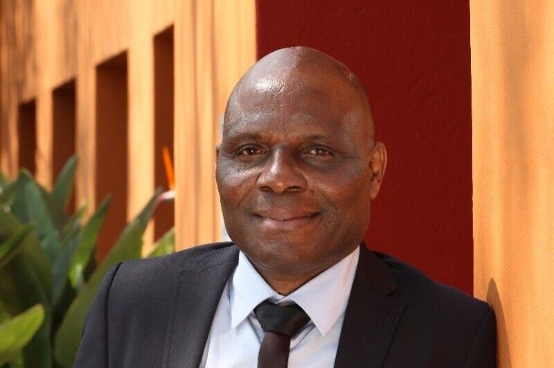Journalist Fidelis Zvomuya is smiling whilst posing for a photo